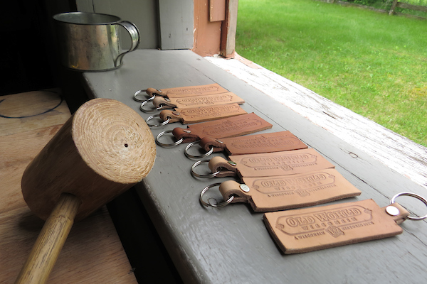 Numerous leather key chains and a wooden hammer